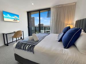 a bedroom with a large bed with a large window at Oceanview Luxury Escape Oracle Tower 2 Level 24 in Gold Coast +24 photos
