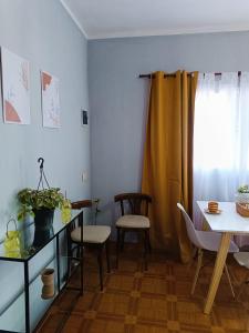 a living room with a table and chairs and a dining room at Sol de Mayo in Tinogasta