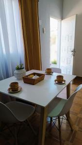 a white table with two chairs and a box on it at Sol de Mayo in Tinogasta +5 photos