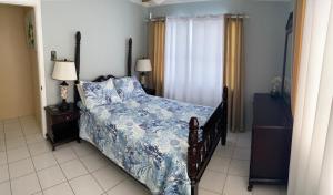 a bedroom with a bed with a blue comforter at Northeast Bay Escape 