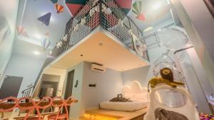 a childs room with a play room with a staircase and chairs at Sunway Grid Loft Suite by Nest Home【Olympic Size Pool】 in Kampong Pendas