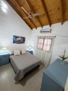 a bedroom with a bed and a ceiling fan at ElCapullo - Paso de la Patria in Paso de la Patria