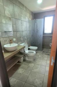 ein Badezimmer mit Toilette und Waschbecken in der Unterkunft Casa de Campo Vuelta de Obligado in Vuelta de Obligado