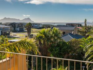 a view of houses and palm trees from a balcony at La Belle Maison - Ruakaka Holiday Apartment in Ruakaka