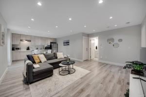 a living room with a couch and a table at Spacious 1BR Suite Near Capilano Bridge & Trails in North Vancouver