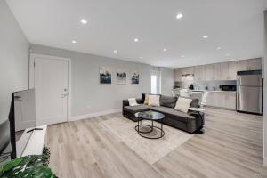 a living room with a couch and a table at Spacious 1BR Suite Near Capilano Bridge & Trails in North Vancouver +18 photos