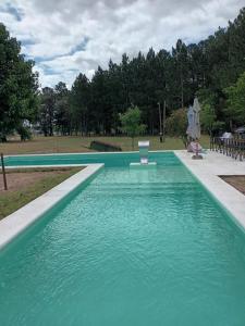 a large swimming pool with turquoise blue water at Complejo Cumelen in Gualeguaychú