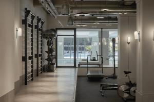 a fitness room with a gym with a treadmill at Conrad Athens The Ilisian in Athens