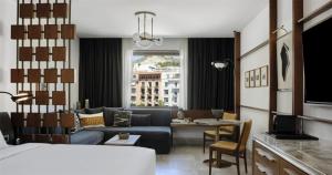 a hotel room with a couch and a living room at Conrad Athens The Ilisian in Athens +13 photos