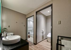 a bathroom with a sink and a toilet at Hinode Hills Niseko Village in Niseko +67 photos