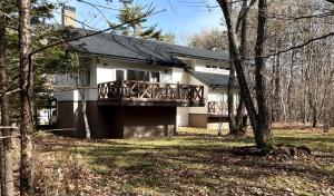 a house with a deck in the woods at Villa Lina - 北軽井沢で四季折々の自然を楽しむプライベート貸別荘 最大6名 in Naganohara +42 photos