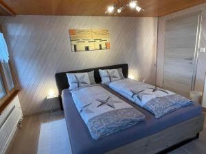 a bed with two pillows at Ferienwohnung Hälmli in Heiden