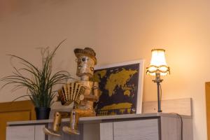 a table with a lamp and a statue on top of it at Kefir & Bun Hostel in Kaunas