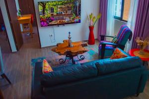 a living room with a blue couch and a table at Full Kitchen, Great View, Historic Center, Quiet in Puebla