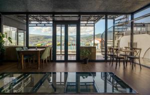 a room with a table and chairs and glass doors at Tato in Tbilisi City