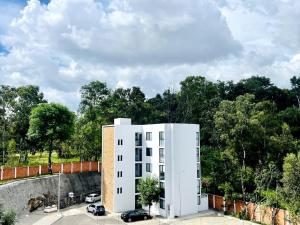 a white building with cars parked in a parking lot at Full Kitchen, Great View, Historic Center, Quiet in Puebla