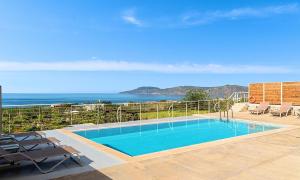 a swimming pool with a view of the ocean at Vista Mare Villa Beheizter Pool in Georgioupoli