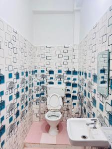 a bathroom with a toilet and a sink at Rita Shree Homestay At Ayodhya Highway in Sultānpur