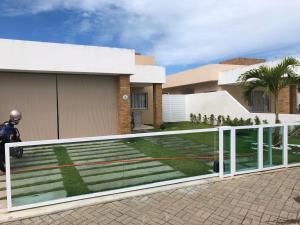 ein Haus mit einem Zaun davor in der Unterkunft CASA CONDOMINIO COSTA PARADIZO 3 Quartos in Barra dos Coqueiros