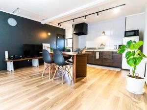 a kitchen and living room with a table and chairs at Rino-Haku 01 in Anan