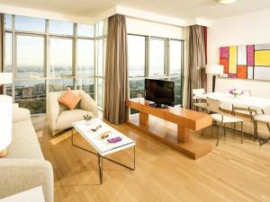 a living room with a couch and a table at Ibis Abu Dhabi Gate in Abu Dhabi