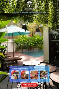 a sign for a free hospice with a table and chairs at Hoianese Pool & Sunset Hotel - A Member Of Hoianese Cultural Experiential Hotel in Hoi An