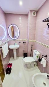 a pink bathroom with a toilet and a sink at ELITE Golden Stay - Luxury Apartments in Tangier +35 photos