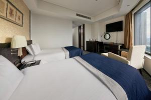 Postel nebo postele na pokoji v ubytování Park Hotel Tokyo