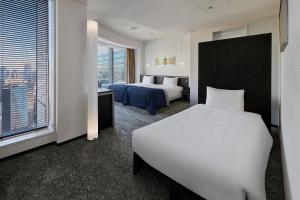 Postel nebo postele na pokoji v ubytování Park Hotel Tokyo