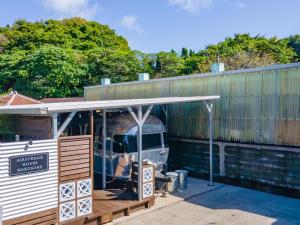 an old truck is sitting in a building at Air Stream House Nakasone in Nakijin