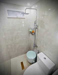 Un baño con un inodoro blanco y un lavabo. en Kahlua, en Sampong