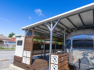 a bus stop with a building with a roof at Air Stream House Nakasone in Nakijin