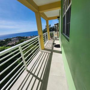 a balcony of a house with a view of the ocean at Belle View Haven in Canefield