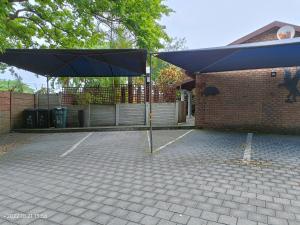 a large blue umbrella sitting in a parking lot at DaaiPlek Holiday home in Richards Bay