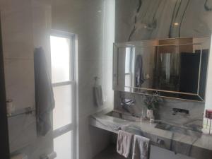 a bathroom with a sink and a mirror at beautiful house near the consulate in Manuel F. Martínez +5 photos