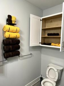 a bathroom with a toilet and a stack of towels at Blue Diamond Dream in Bennington