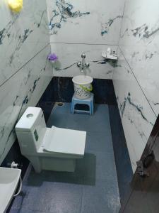 a bathroom with a toilet and a sink at Himagni Homestay - Entire Villa in Sakleshpur