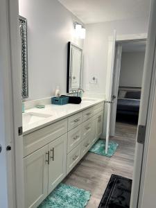 a white bathroom with a sink and a mirror at Blue Diamond Dream in Bennington +54 photos
