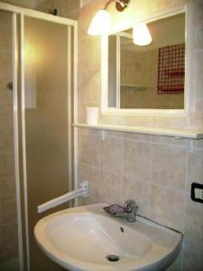 a bathroom with a sink and a mirror at Wohnung Caprifoglio In Miasino in Miasino