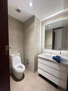 a bathroom with a toilet and a sink and a mirror at Colombo Stay - Skyview Retreat in Colombo +12 photos