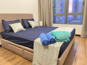 a bed with blue pillows on it in a bedroom at Colombo Stay - Skyview Retreat in Colombo