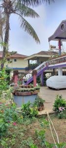a house with a purple bridge and some plants at Gardenia Inn in Madikeri