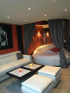 a living room with two beds and a couch at Elixxir in Cap d'Agde