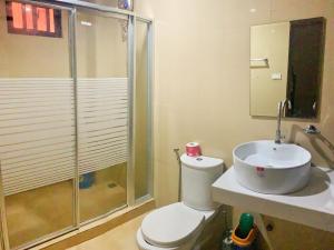 a bathroom with a shower and a toilet and a sink at Villa Monica Hotel in Balatero +11 photos