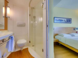 a bathroom with a toilet sink and a shower at ibis Bengaluru Outer Ring Road in Bengaluru