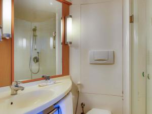 a bathroom with a sink and a shower and a toilet at ibis Bengaluru Outer Ring Road in Bengaluru