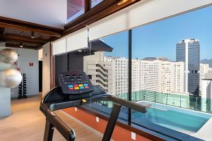 a gym with a view of the city at Moderno com piscina e perto da praia in Rio de Janeiro