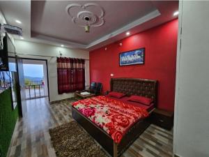 a red bedroom with a bed with a red wall at Hotel Dream House in Kanatal