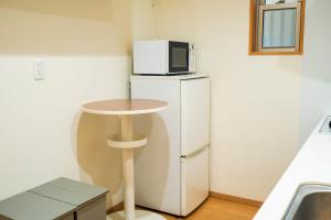 Kuchyň nebo kuchyňský kout v ubytování Homey Inn SANNO