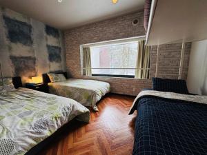 Ένα ή περισσότερα κρεβάτια σε δωμάτιο στο 星野度假村Village Alpha Tomamu复式公寓套房